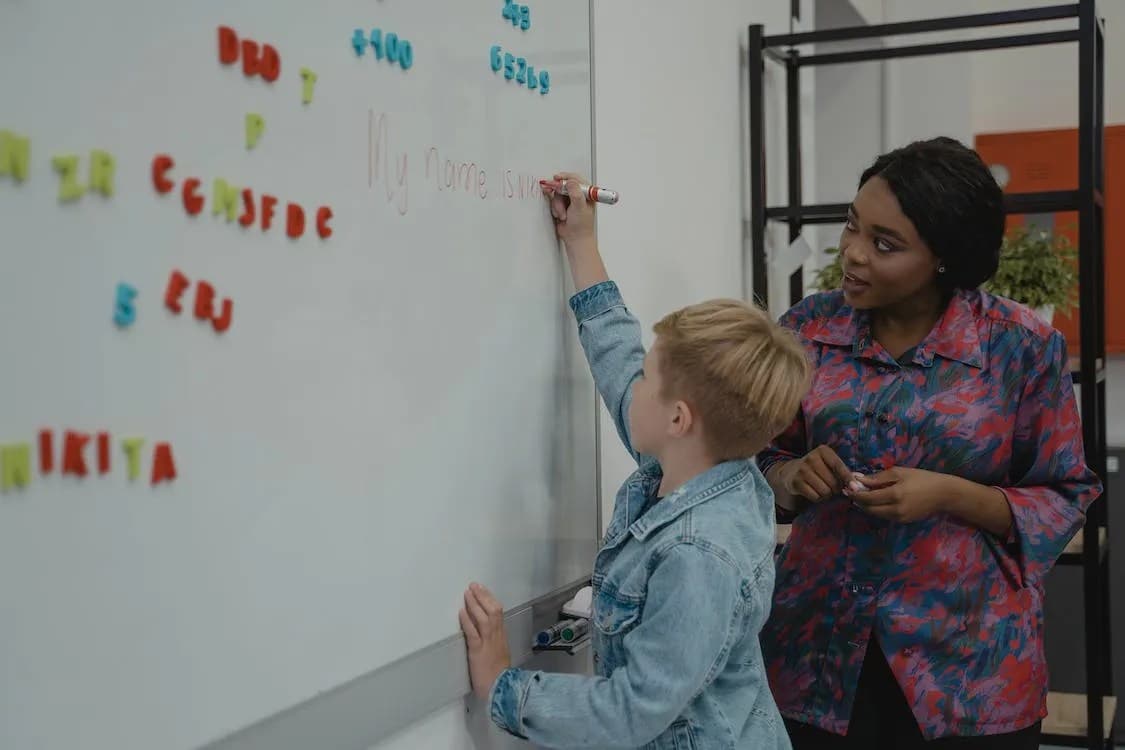 Black teacher instructing a student.