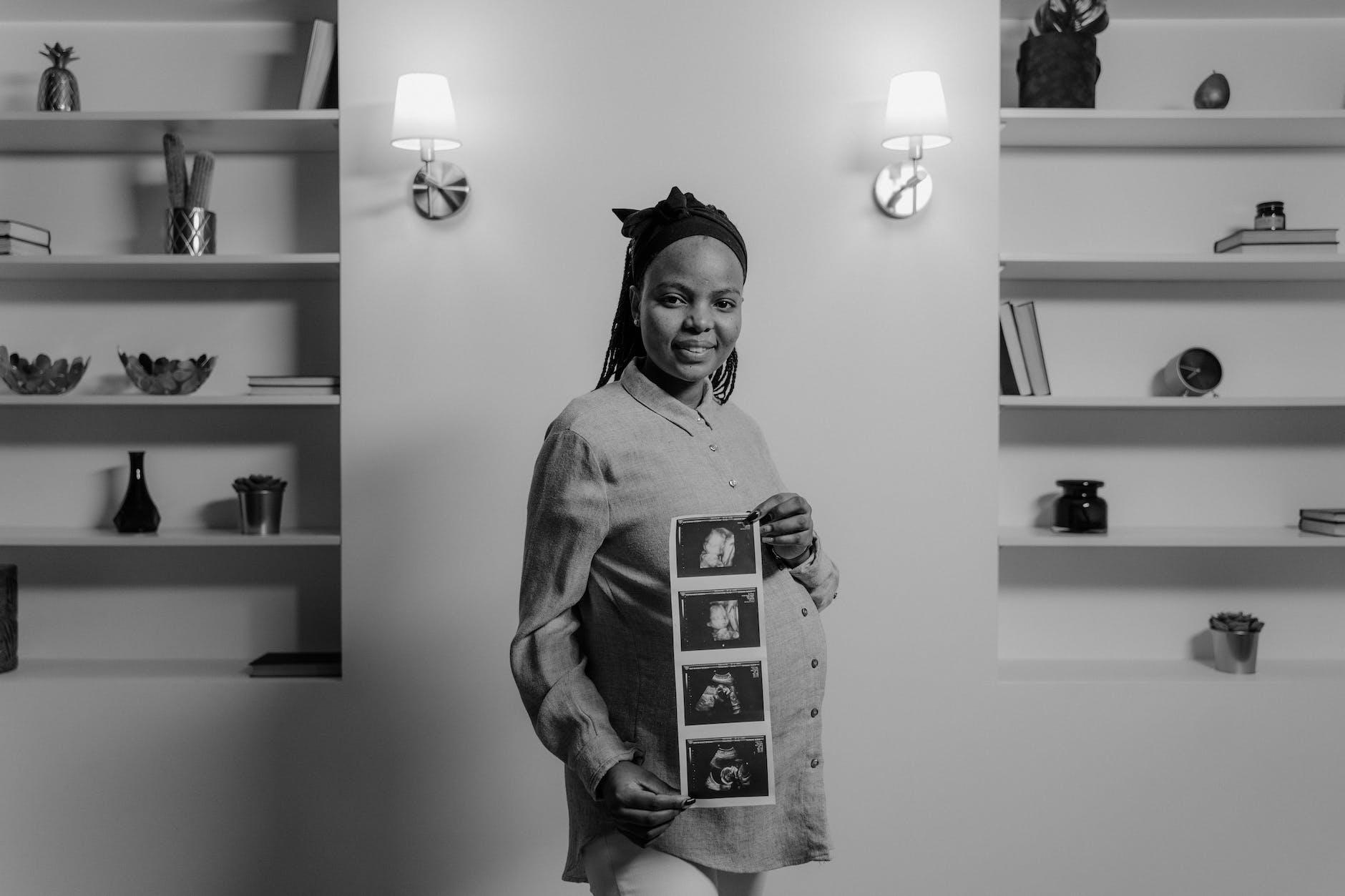 a woman holding ultrasound images