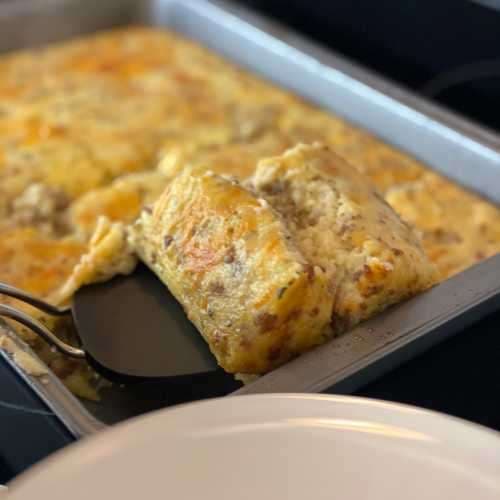 Spatula picking up grits casserole slice